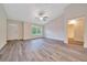 Open-plan living space with vaulted ceiling, front door, large windows, and view to a bathroom at 10675 Sw 69Th Ter, Ocala, FL 34476