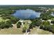 Expansive aerial view of a lakefront property surrounded by lush forest at 10893 Se 141 Avenue Rd, Ocklawaha, FL 32179