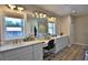 Bright bathroom with double vanity, modern fixtures, and a walk-in shower at 10893 Se 141 Avenue Rd, Ocklawaha, FL 32179