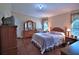 Bedroom with wood floors, matching furniture, and lots of natural light at 10893 Se 141 Avenue Rd, Ocklawaha, FL 32179