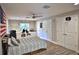 Spacious bedroom with laminate floors, a ceiling fan, an American flag, a panda, and built-in storage at 10893 Se 141 Avenue Rd, Ocklawaha, FL 32179