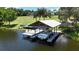 Private boat dock featuring seating, a boat lift, and a watercraft ready for lake adventures at 10893 Se 141 Avenue Rd, Ocklawaha, FL 32179
