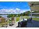 Outdoor deck with seating and panoramic views of the lake and pool area at 10893 Se 141 Avenue Rd, Ocklawaha, FL 32179