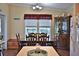 Dining area with dark wooden table, china cabinet, and backyard view at 10893 Se 141 Avenue Rd, Ocklawaha, FL 32179
