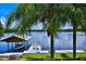 Dock on the water with a boat lift, seating, and an array of water equipment at 10893 Se 141 Avenue Rd, Ocklawaha, FL 32179