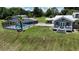 Exterior view of the home featuring a screened pool and outdoor seating area at 10893 Se 141 Avenue Rd, Ocklawaha, FL 32179