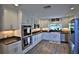 Well-lit kitchen with granite countertops, stainless steel appliances, and custom cabinetry at 10893 Se 141 Avenue Rd, Ocklawaha, FL 32179