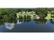 Stunning lake view of a home with a pool, lush greenery, and private boat docks at 10893 Se 141 Avenue Rd, Ocklawaha, FL 32179