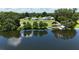 Beautiful lake view showcasing the home, pool, docks, and surrounding landscape at 10893 Se 141 Avenue Rd, Ocklawaha, FL 32179