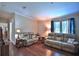 Cozy living room with hardwood floors, neutral walls, and comfortable seating at 10893 Se 141 Avenue Rd, Ocklawaha, FL 32179
