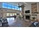 Bright living room featuring a stone fireplace, hardwood floors, and beautiful lake views at 10893 Se 141 Avenue Rd, Ocklawaha, FL 32179