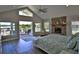 Spacious bedroom with high ceilings, a fireplace, and access to a private balcony overlooking the lake at 10893 Se 141 Avenue Rd, Ocklawaha, FL 32179