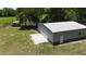 Exterior of a large metal outbuilding with a roll-up door and side entry door at 10893 Se 141 Avenue Rd, Ocklawaha, FL 32179