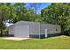 Large metal outbuilding or shop with a roll-up door and separate entry door at 10893 Se 141 Avenue Rd, Ocklawaha, FL 32179