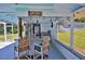 Outdoor bar area under a covered patio with bar stools, a countertop, string lights, and lake-themed decorations at 10893 Se 141 Avenue Rd, Ocklawaha, FL 32179