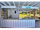 Outdoor bar featuring a counter, corrugated steel, a mini-fridge, string lights and a 'Relax' sign at 10893 Se 141 Avenue Rd, Ocklawaha, FL 32179