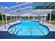 A stunning screened-in pool with a waterfront view provides a relaxing outdoor space at 10893 Se 141 Avenue Rd, Ocklawaha, FL 32179