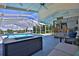 Relaxing indoor pool area with a fire pit, lake views, bar with seating, and a patio lounge at 10893 Se 141 Avenue Rd, Ocklawaha, FL 32179