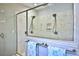 Modern walk-in shower featuring dual shower heads and elegant marble tiling at 10893 Se 141 Avenue Rd, Ocklawaha, FL 32179