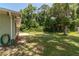 Lush backyard with mature trees, garden beds, and a well-maintained lawn, creating a serene outdoor space at 11645 Mallard Ct, Dunnellon, FL 34432
