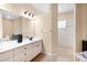 Bright bathroom with double sinks, black fixtures and a walk-in shower at 11645 Mallard Ct, Dunnellon, FL 34432
