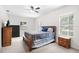 Bright primary bedroom with neutral walls, ceiling fan, and natural light at 11645 Mallard Ct, Dunnellon, FL 34432