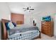 Large primary bedroom with carpet flooring, ceiling fan, and ensuite bath at 11645 Mallard Ct, Dunnellon, FL 34432