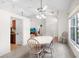 Open dining area with a vaulted ceiling, ceiling fan, and access to the kitchen and living room at 11645 Mallard Ct, Dunnellon, FL 34432