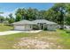 Charming single-story home with well-maintained lawn, attached garage, and inviting front entrance at 11645 Mallard Ct, Dunnellon, FL 34432