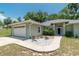 Beautiful front exterior features a manicured lawn, stone garden, and an attached two-car garage at 11645 Mallard Ct, Dunnellon, FL 34432