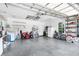 Spacious garage with overhead storage, washer, dryer, lawn mower and bright overhead lighting at 11645 Mallard Ct, Dunnellon, FL 34432
