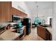 Open kitchen area with modern appliances, wood cabinets, and natural light at 11645 Mallard Ct, Dunnellon, FL 34432