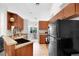 Traditional kitchen with wood cabinets, black appliances, and tile flooring at 11645 Mallard Ct, Dunnellon, FL 34432