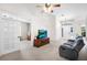 Inviting living room showing vaulted ceilings, a TV on a console, and the front door area in the background at 11645 Mallard Ct, Dunnellon, FL 34432