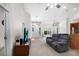 Comfortable living room showcasing a blue sofa, a TV on a console, and an open floor plan at 11645 Mallard Ct, Dunnellon, FL 34432