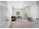 Bright office space featuring French doors, neutral walls, and ceiling fan at 11645 Mallard Ct, Dunnellon, FL 34432