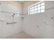 This shower showcases sleek gray and white tile, a shower head, and a window letting in natural light at 11645 Mallard Ct, Dunnellon, FL 34432