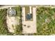 Aerial shot of modern home with a long driveway, another property nearby, and surrounding greenery at 12251 Sw 67Th Ln, Ocala, FL 34481