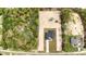 Aerial view of modern home, with a large, cleared lot, long driveway, and verdant surrounding trees at 12251 Sw 67Th Ln, Ocala, FL 34481
