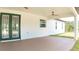 Spacious covered patio featuring a ceiling fan and painted concrete floors at 12251 Sw 67Th Ln, Ocala, FL 34481