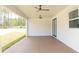 Spacious covered patio showcasing a ceiling fan and painted concrete floors at 12251 Sw 67Th Ln, Ocala, FL 34481