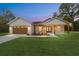 Charming single-story home with a tan garage door and a lovely wood-accented porch at 12251 Sw 67Th Ln, Ocala, FL 34481
