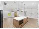 Modern open concept kitchen with island, stainless appliances and wood flooring at 12251 Sw 67Th Ln, Ocala, FL 34481