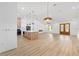 Bright, open living space with a modern kitchen and wood-look flooring throughout at 12251 Sw 67Th Ln, Ocala, FL 34481