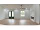Open living room featuring wood-look floors, a fireplace, and a ceiling fan at 12251 Sw 67Th Ln, Ocala, FL 34481