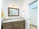Bathroom features a wood vanity, modern mirror, and linen closet at 15620 Nw 112Th Ave, Reddick, FL 32686
