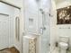 Bathroom features glass shower, toilet and decorative mirror at 15620 Nw 112Th Ave, Reddick, FL 32686