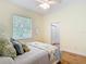Bedroom featuring wooden floors, ceiling fan, and a bright window to the exterior at 15620 Nw 112Th Ave, Reddick, FL 32686