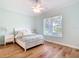 Bedroom featuring hardwood floors, natural light, and a plush bed with side tables at 15620 Nw 112Th Ave, Reddick, FL 32686