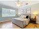 Bedroom features a large window providing natural light and hardwood flooring at 15620 Nw 112Th Ave, Reddick, FL 32686